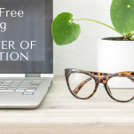 laptop on desk with glasses